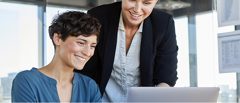 Two colleagues collaborating at a laptop. 